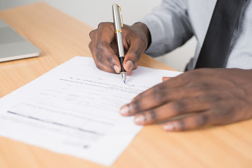 black man signing mobile home lease